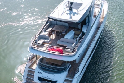 Luxurious 2026 Princess X80 yacht cruising on serene waters, featuring spacious deck seating.