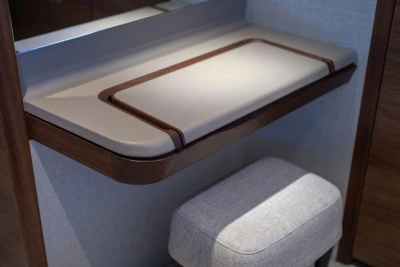 Elegant interior of 2026 Princess X80 yacht with modern desk and stool.