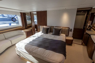 Luxurious 2026 Princess X80 yacht bedroom with elegant decor and natural light.