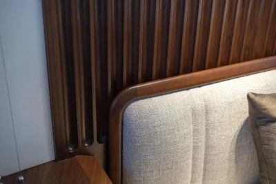 Luxurious interior detail of 2026 Princess X80 yacht with wood paneling and cushioned seating.