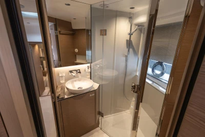Luxurious bathroom in 2023 Princess V50 Open yacht, featuring modern shower and elegant sink.