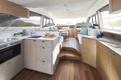Luxurious interior of 2023 Princess F45 yacht with modern kitchen and seating area.