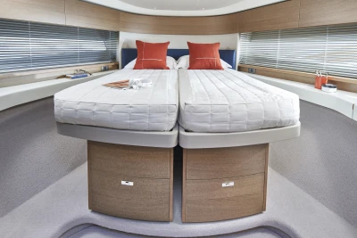 Luxurious 2023 Princess F45 yacht bedroom with twin beds and modern decor.