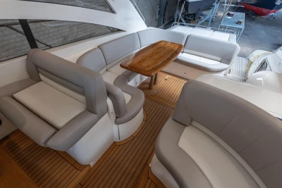 Luxurious 2007 Princess V48 yacht interior with elegant seating and wooden table.