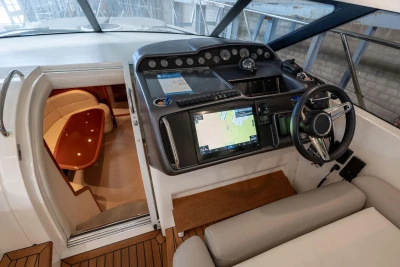 Interior view of 2007 Princess V48 yacht cockpit with navigation system and seating area.
