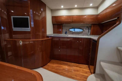 Luxurious 2007 Princess V48 yacht interior with sleek wood cabinetry and modern kitchen amenities.