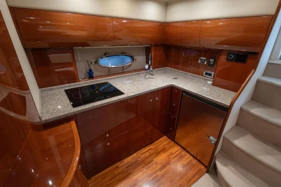 Luxurious kitchen interior of 2007 Princess V48 yacht with modern appliances and wood finish.