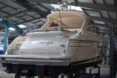 2007 Princess V48 yacht in a boatyard, showcasing sleek design and luxury features.